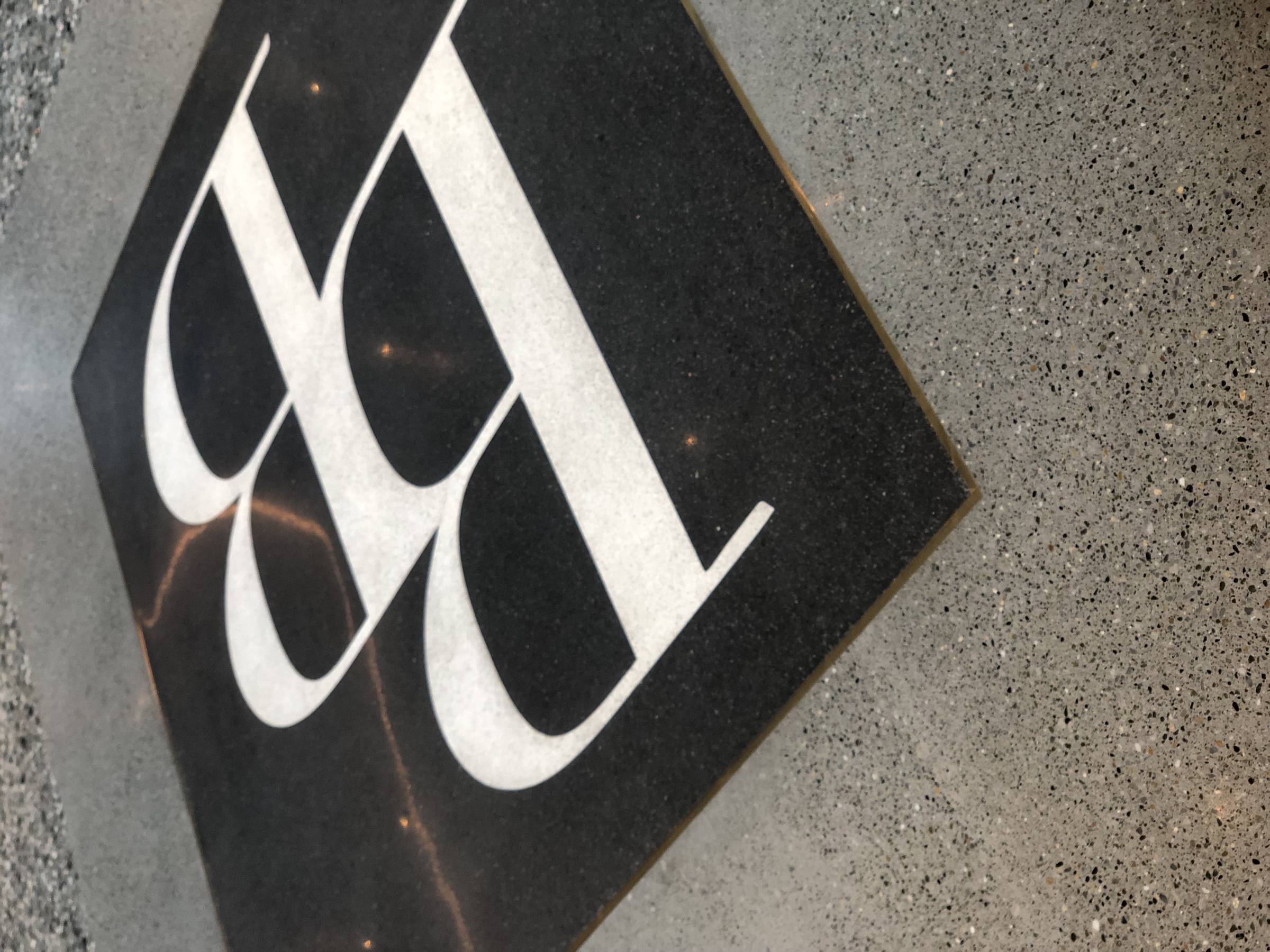 Polished concrete floor detail with logo inlay.