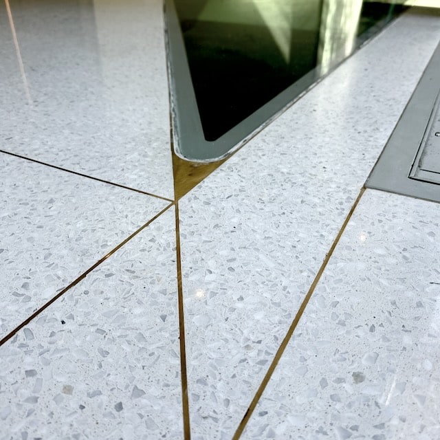 Brass divider strip set into terrazzo.