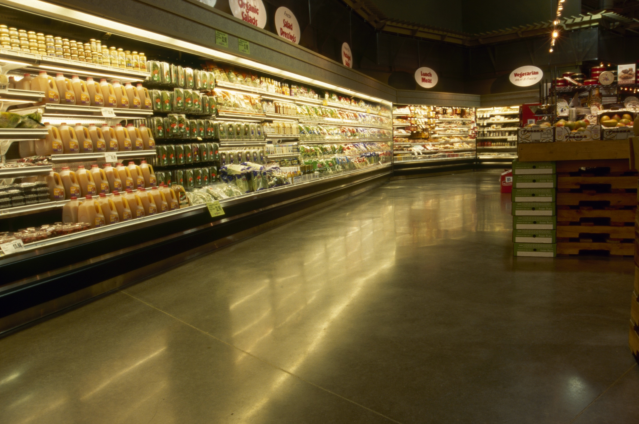 Unnamed grocery store refrigerated aisle with polished concrete floor.