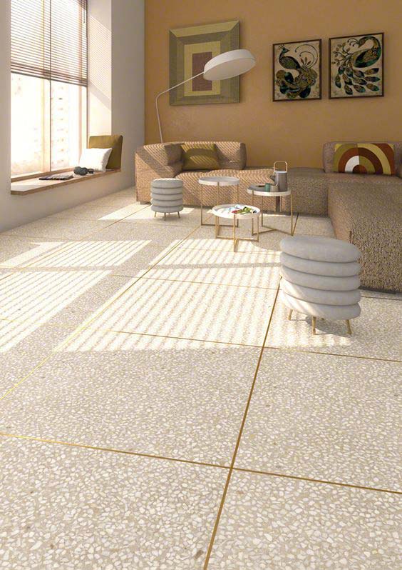 Sunlit living room with gridded terrazzo floor.