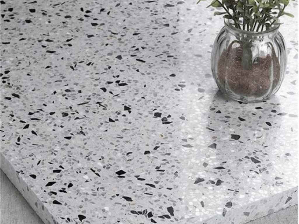 Close detail of white terrazzo with dark aggregate.